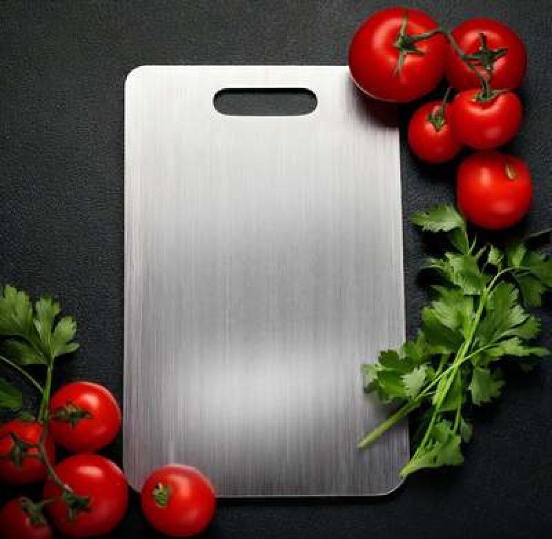 Katori Titanium Cutting Board with fresh tomatoes and parsley on a dark surface